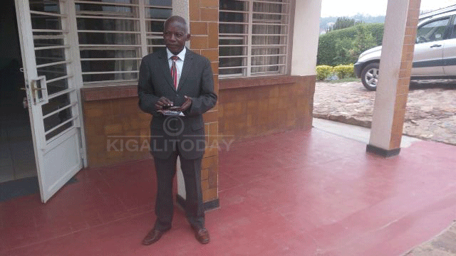 Niyitegeka Sosthene ahagaze imbere y'inzu ye aho atuye muri Rukira ya II mu Murenge wa Remera