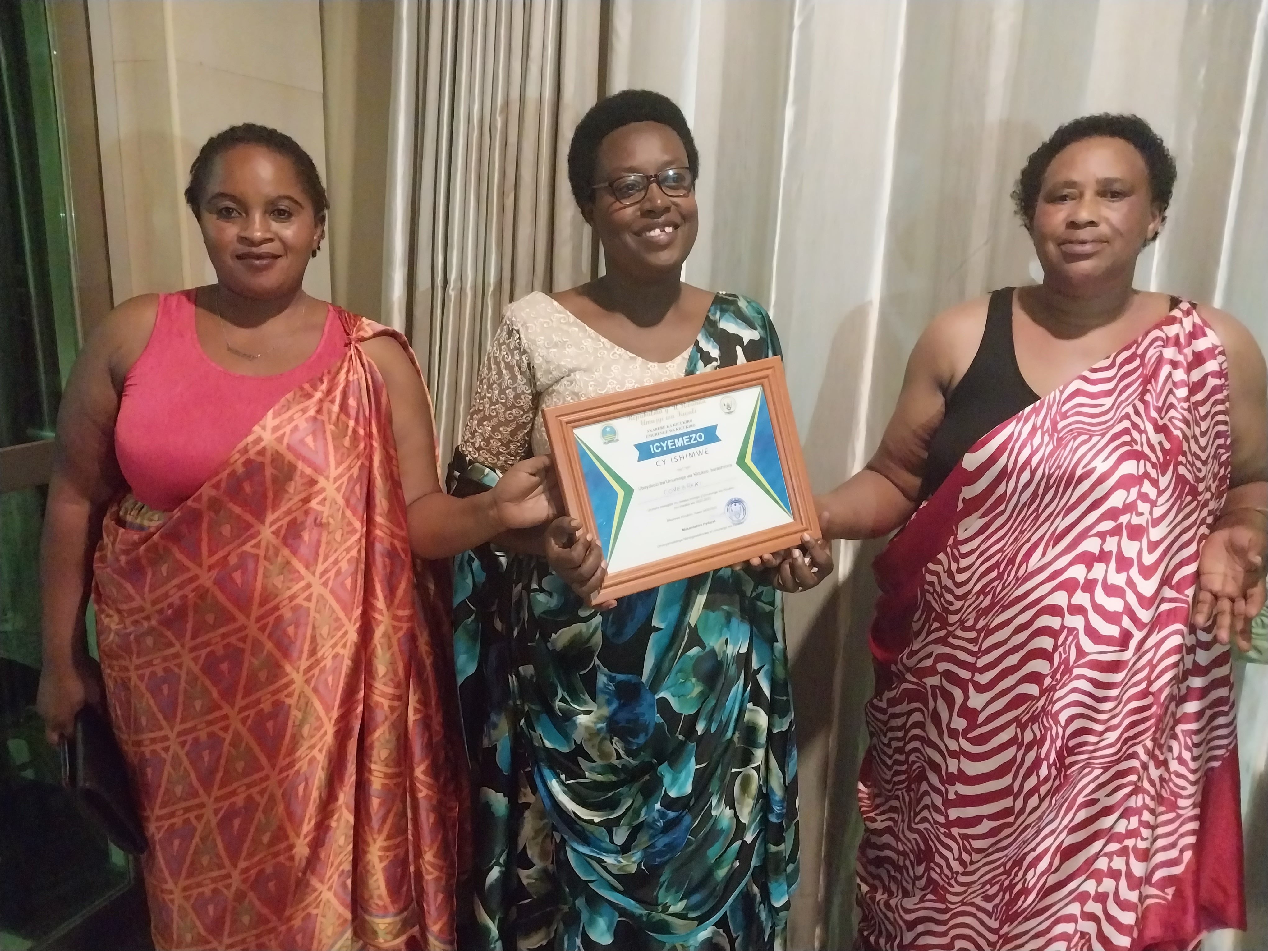 Anonciata Uzamukunda (uri hagati) hamwe n'abandi banyamuryango ba Koperative KOVEBRAKI bishimiye ishimwe bagenewe n'Ubuyobozi bw'Umurenge 