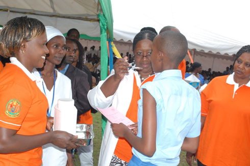 Aha nabwo Minisitiri w'ubuzima mu Rwanda yatangaga ikinini cy'inzoka kuri uwo mwana w'umukobwa.