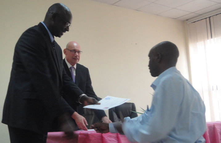 Minisitiri Busingye atanga inyemezabumenyi ku munyamategeko wa Leta wahuguwe.