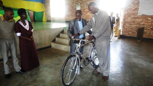 Umwe mubashimiwe ashyikirizwa igare.