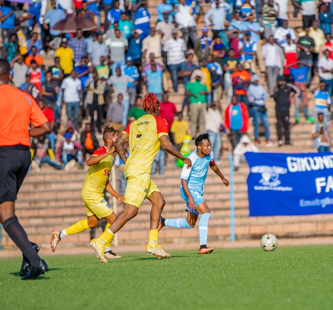 Nshuti Dominique Savio ufite umupira acungirwa hafi na Essomba Willy Onana na Raphael Osaluwe ba Rayon Sports