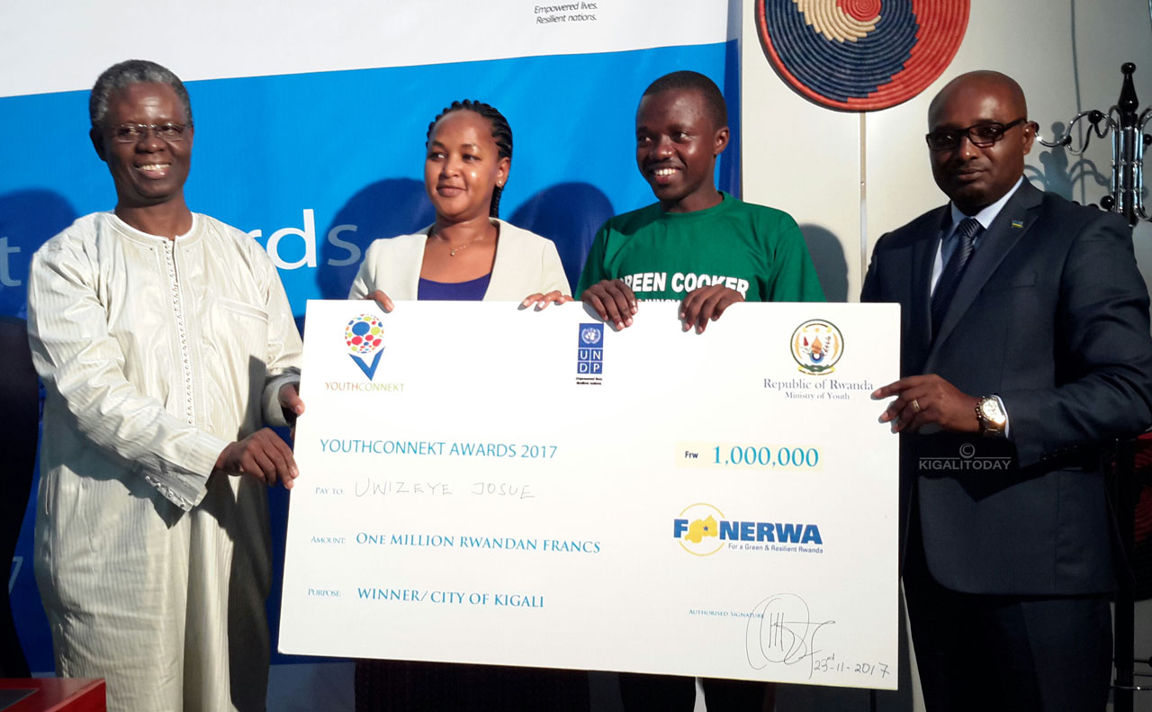 Abayobozi barimo Ministiri Rose Mary Mbabazi batanga igihembo kuri Uwizeye Josue