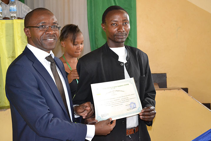 Musonera ashyikiriza imyamyabushobozi umwe mu banyeshuri barangije amasomo y'imyuga muri IPRC-EAST.