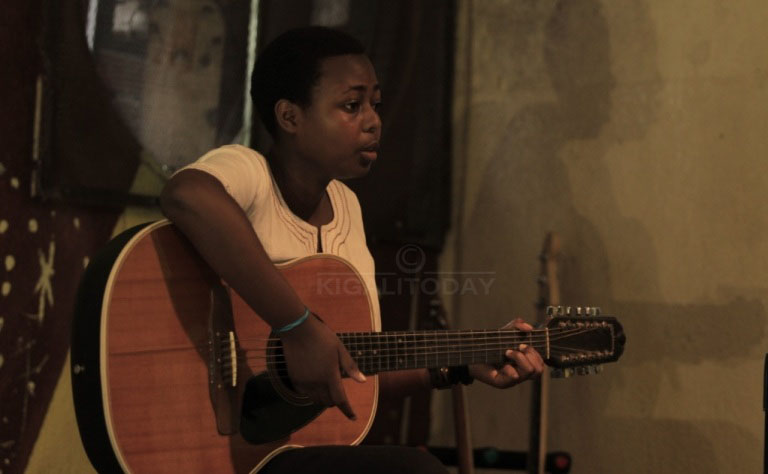 Umwe mu bakobwa witabiriye irushanwa aririmba akoresha gitari 
